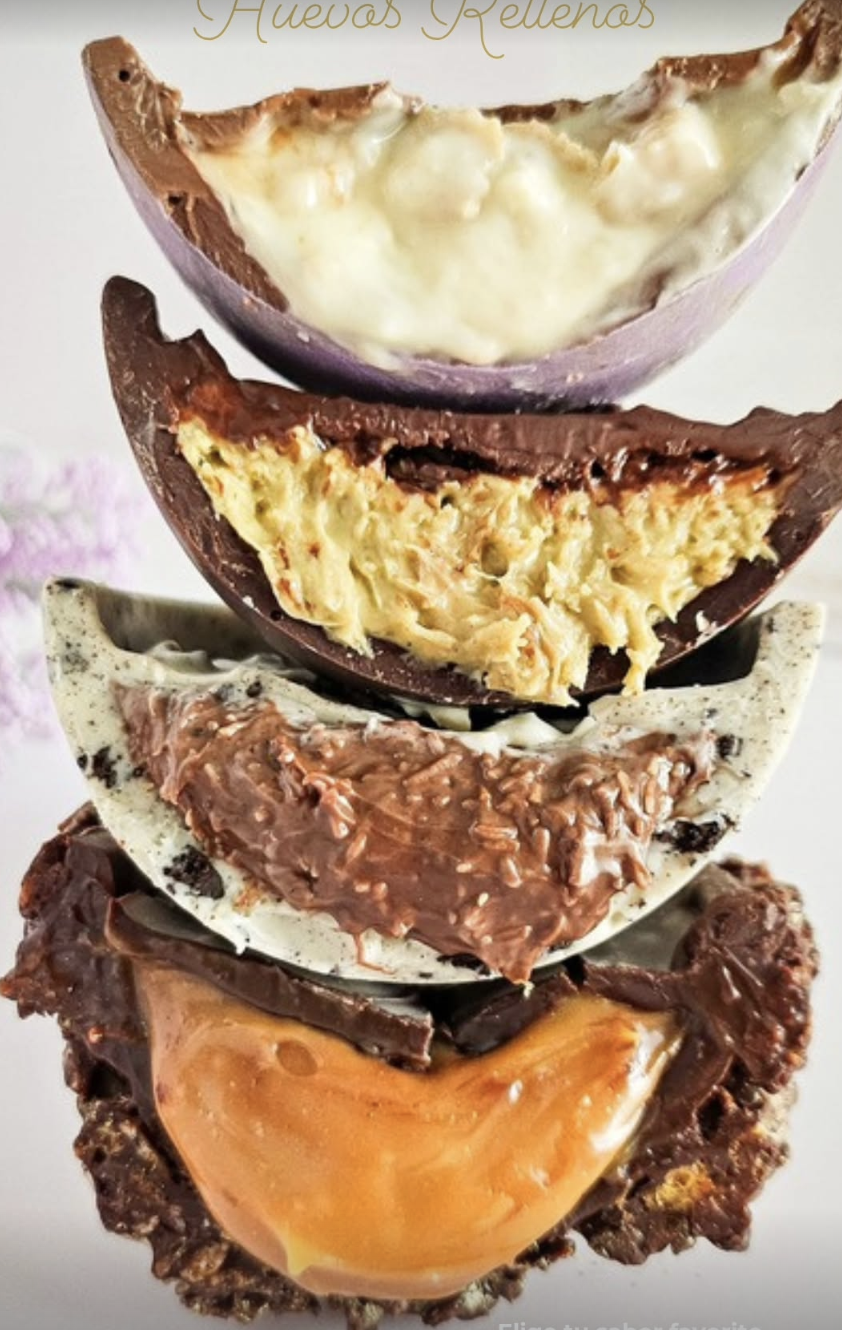 Four filled chocolate Easter eggs cut open showing pistachio, cookies and cream, dulce de leche, and coconut fillings